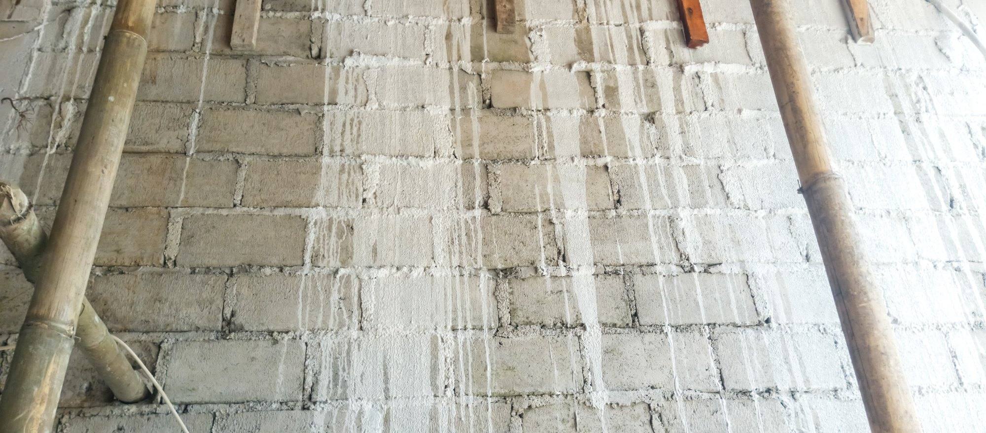 White mineral streaks running down a concrete block wall